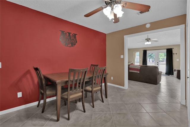 dining area with ceiling fan, french doors, and light tile patterned floors