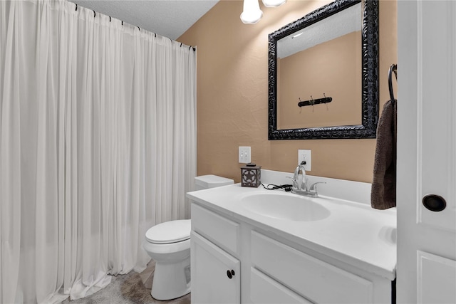 bathroom featuring vanity, curtained shower, toilet, and a textured ceiling