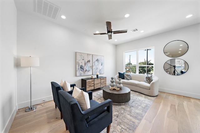 living room with ceiling fan and light hardwood / wood-style floors