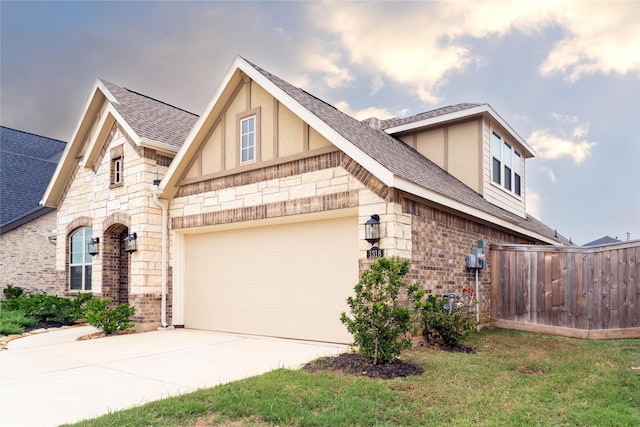 view of side of property featuring a garage and a lawn