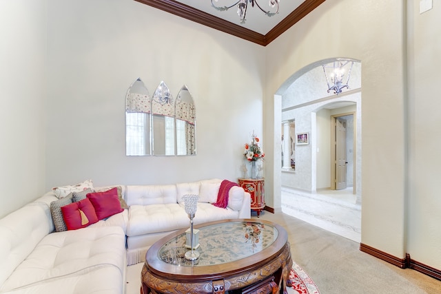 carpeted living room with a notable chandelier, a towering ceiling, and crown molding