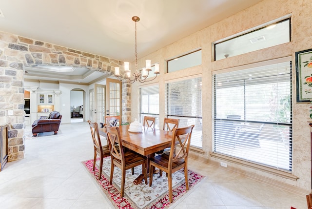 dining room featuring a chandelier, crown molding, and light tile patterned flooring