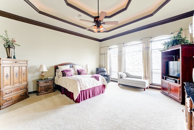 carpeted bedroom featuring ceiling fan, a raised ceiling, and ornamental molding