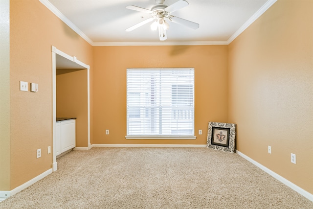 carpeted empty room with ceiling fan and ornamental molding