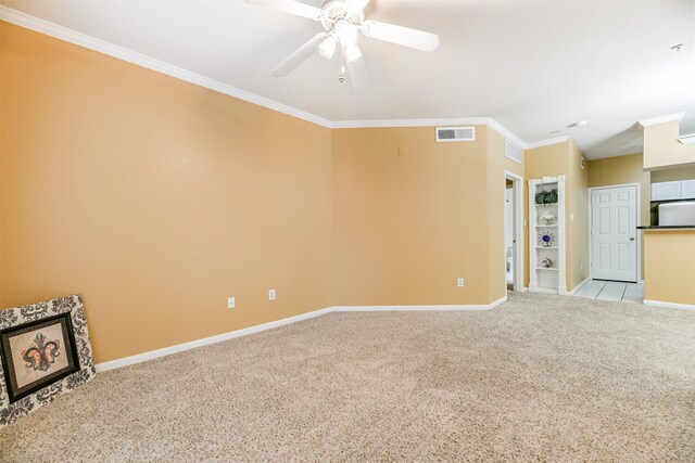 spare room with light carpet, crown molding, and ceiling fan