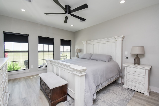 bedroom with ceiling fan and light hardwood / wood-style flooring