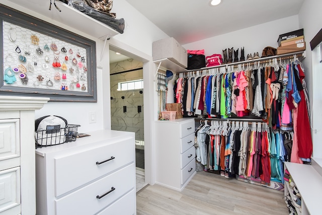 walk in closet featuring light hardwood / wood-style flooring