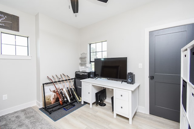 home office featuring light hardwood / wood-style flooring and ceiling fan