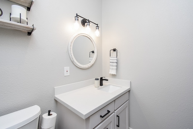 bathroom with vanity and toilet