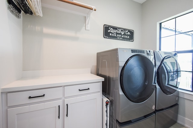 laundry area with cabinets and independent washer and dryer