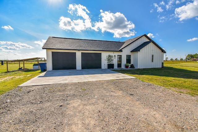 view of front of property with a front yard and a garage