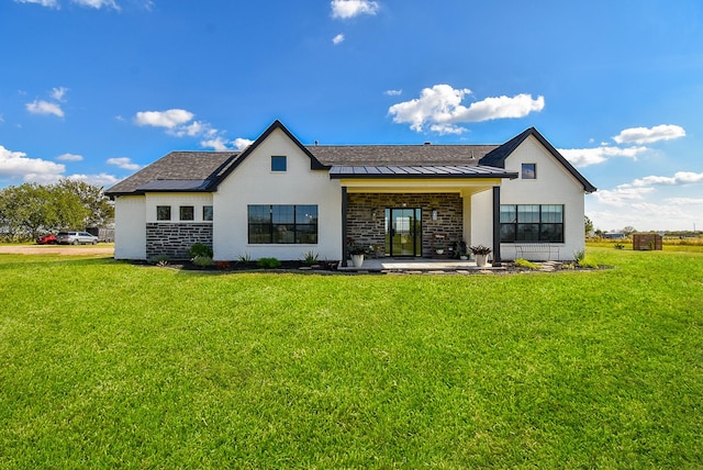 15007 Barak Rd Unit P, Guy, TX 77444 - back of house with a standing seam roof, a lawn, and metal roof
