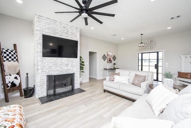 15007 Barak Rd Unit P, Guy, TX 77444 - living area featuring wood finished floors, ceiling fan, recessed lighting, a brick fireplace, and baseboards