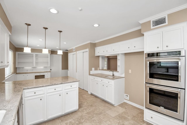 kitchen with white cabinets, decorative light fixtures, light stone counters, and stainless steel double oven