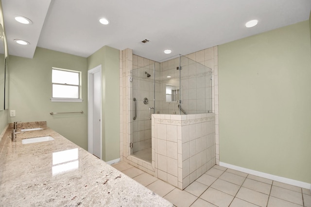 bathroom featuring vanity, tile patterned floors, and a shower with door