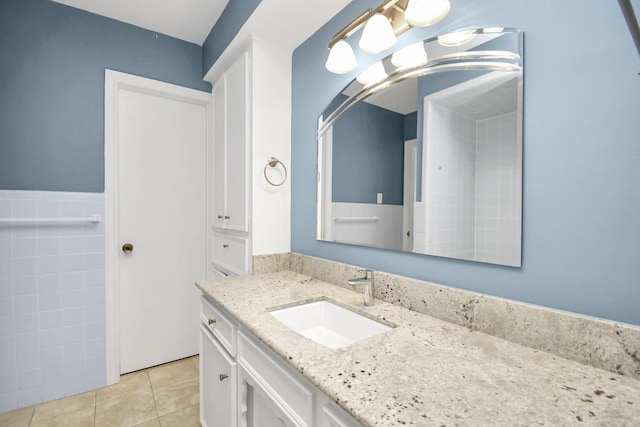 bathroom featuring tile patterned flooring and vanity