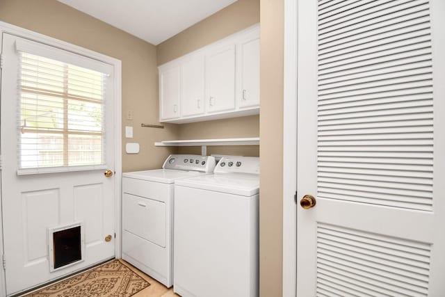 laundry area with cabinets and washing machine and clothes dryer