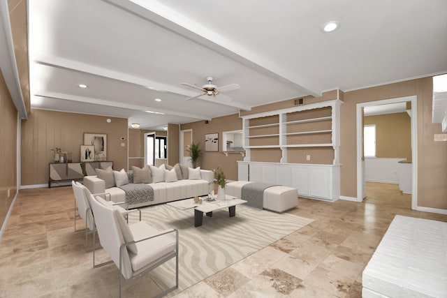 living room featuring wood walls, beamed ceiling, and ceiling fan