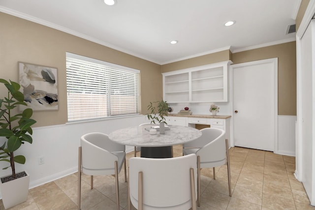 dining space with light tile patterned floors and crown molding