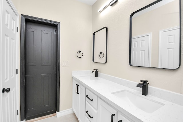 bathroom with tile patterned flooring and vanity