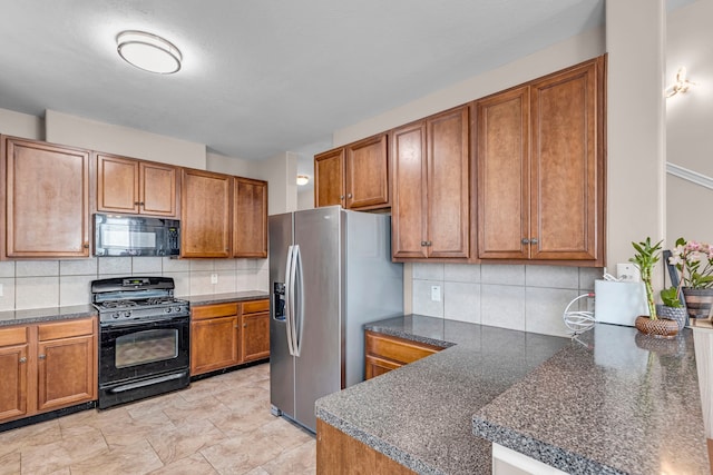 kitchen featuring backsplash, kitchen peninsula, and black appliances