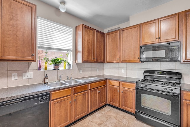 kitchen with sink, tasteful backsplash, and black appliances