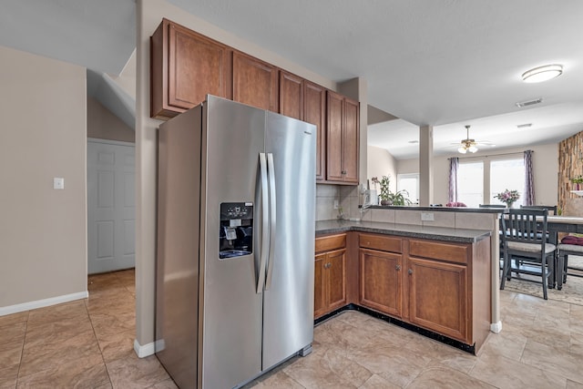 kitchen with kitchen peninsula, stainless steel fridge, tasteful backsplash, and ceiling fan