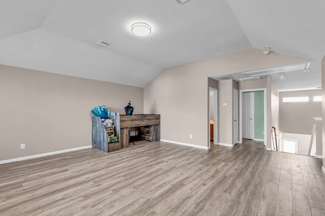 additional living space featuring light hardwood / wood-style flooring and vaulted ceiling