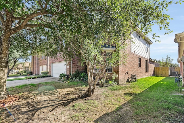 view of side of home featuring a yard and a garage