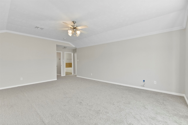 carpeted spare room with ceiling fan, crown molding, and lofted ceiling