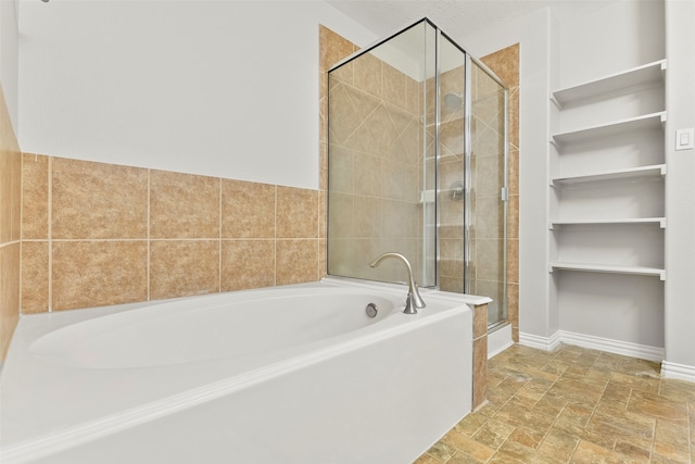 bathroom featuring separate shower and tub