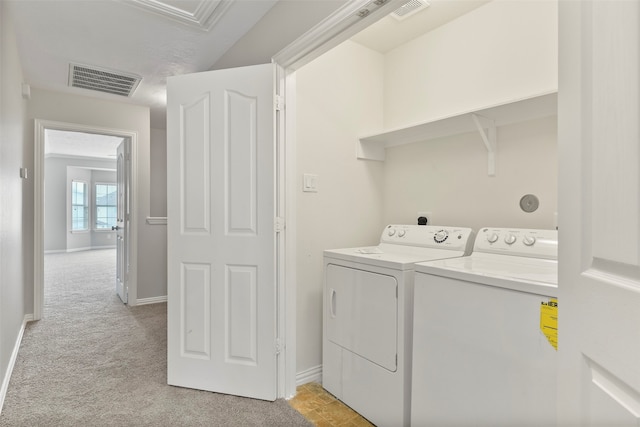 laundry room featuring washing machine and dryer and light carpet