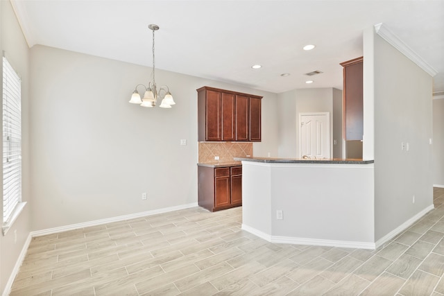 kitchen with pendant lighting, an inviting chandelier, a wealth of natural light, and light hardwood / wood-style flooring