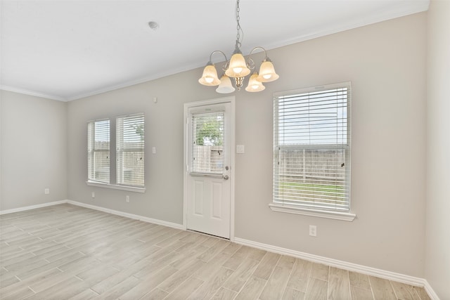 interior space featuring a chandelier, light hardwood / wood-style floors, and ornamental molding