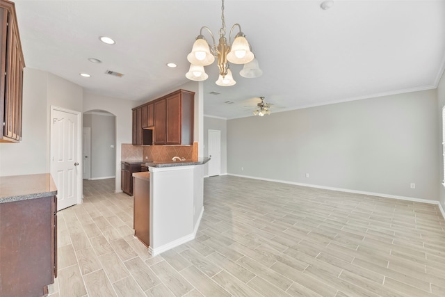 kitchen featuring decorative light fixtures, ceiling fan with notable chandelier, and light hardwood / wood-style floors