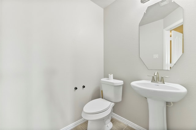 bathroom featuring wood-type flooring, toilet, and sink