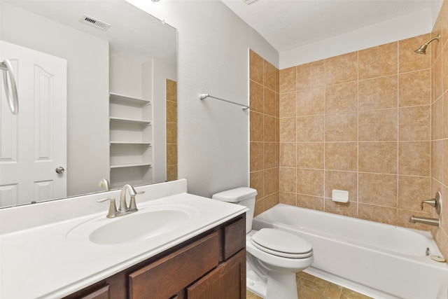 full bathroom with toilet, vanity, a textured ceiling, and tiled shower / bath