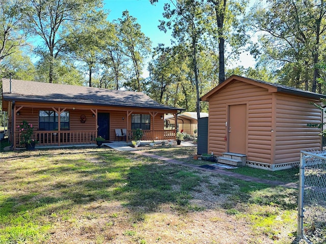 exterior space featuring a carport, a porch, and a lawn