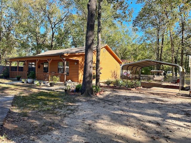 view of front of property featuring a carport and covered porch