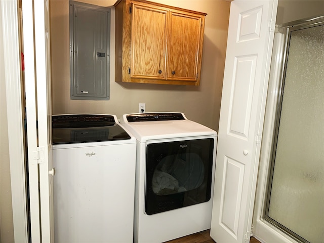 laundry room with cabinets, separate washer and dryer, and electric panel