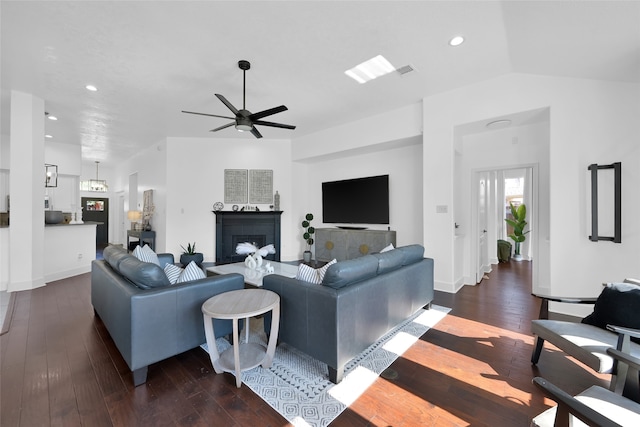 living room featuring ceiling fan, dark wood-type flooring, and lofted ceiling