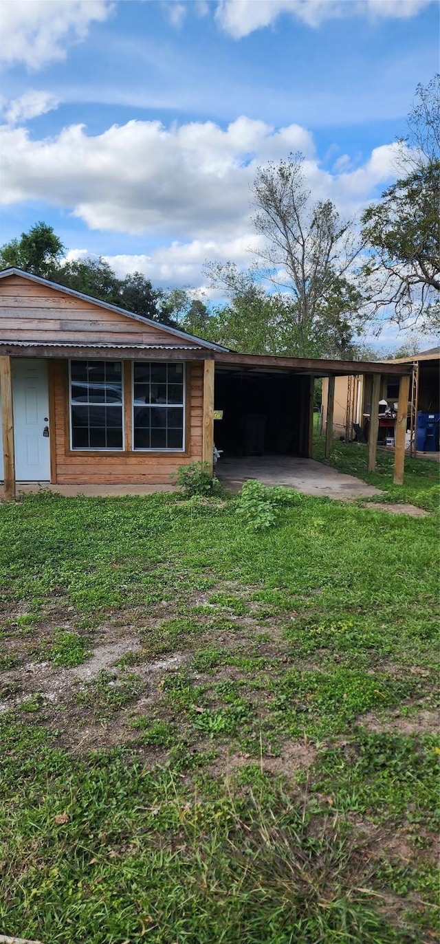 rear view of property with a carport