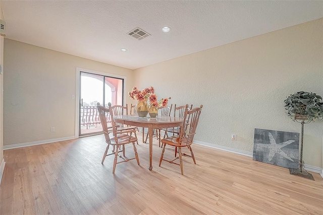 dining space with light hardwood / wood-style flooring