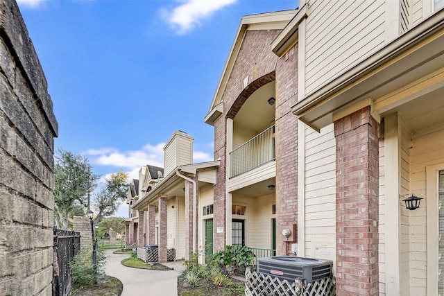 exterior space with a balcony and central air condition unit