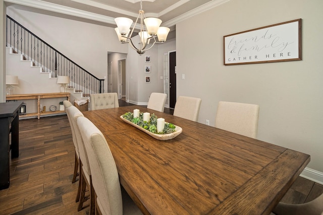 dining space with dark hardwood / wood-style floors, ornamental molding, and an inviting chandelier