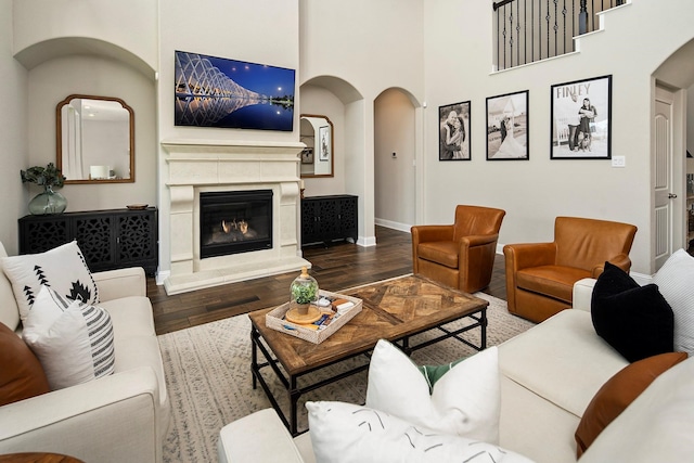 living room with wood-type flooring and a high ceiling