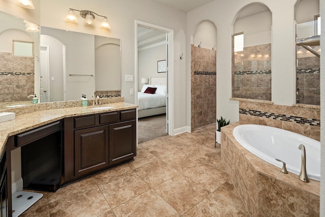 bathroom featuring tile patterned floors, vanity, and independent shower and bath