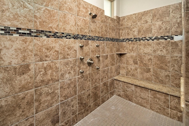 bathroom with tiled shower