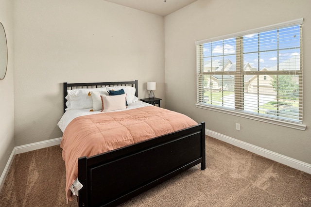 carpeted bedroom featuring multiple windows