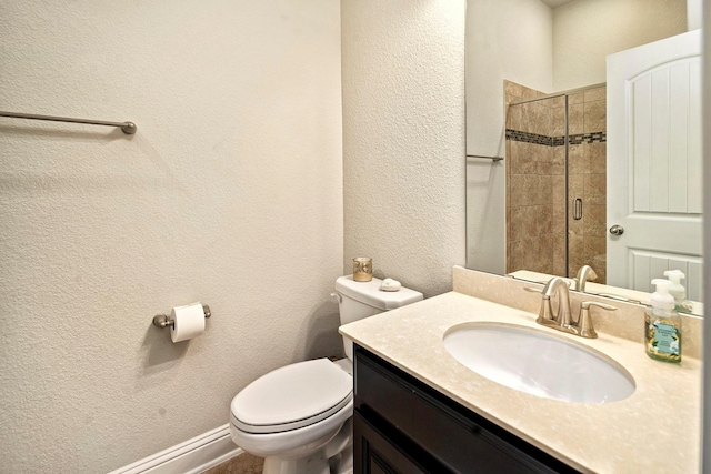 bathroom with vanity, toilet, and a shower with shower door